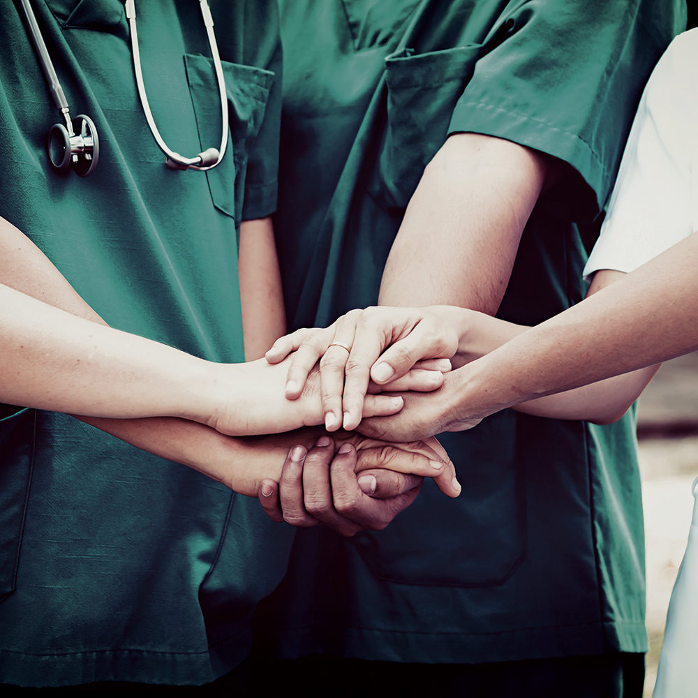 Doctors and nurses coordinate hands. Concept Teamwork