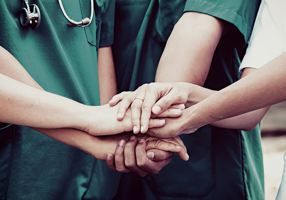 Doctors and nurses coordinate hands. Concept Teamwork